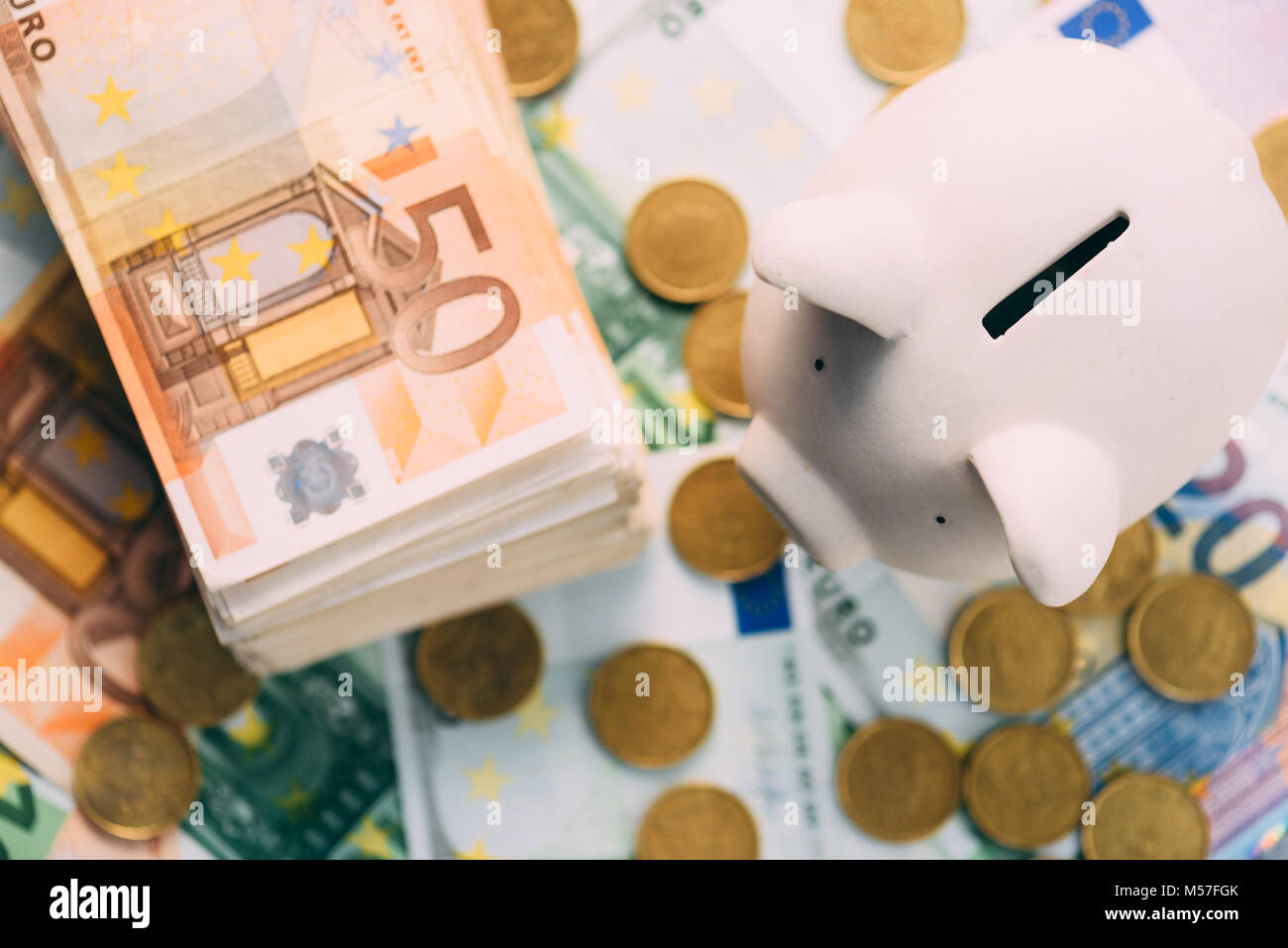 Piggy moneybox with euro cash Stock Photo