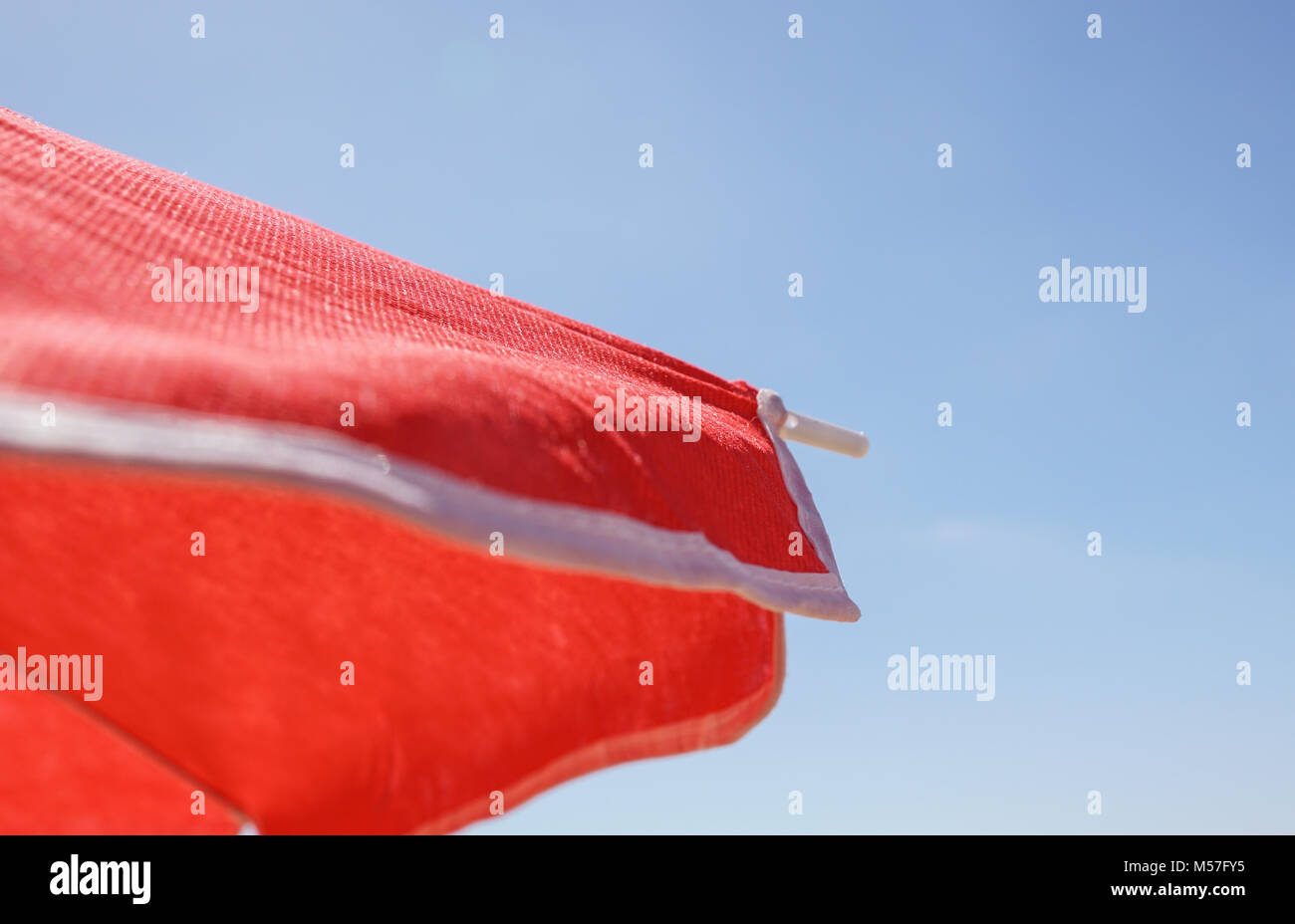 Red sunshade umbrella on the sky background Stock Photo