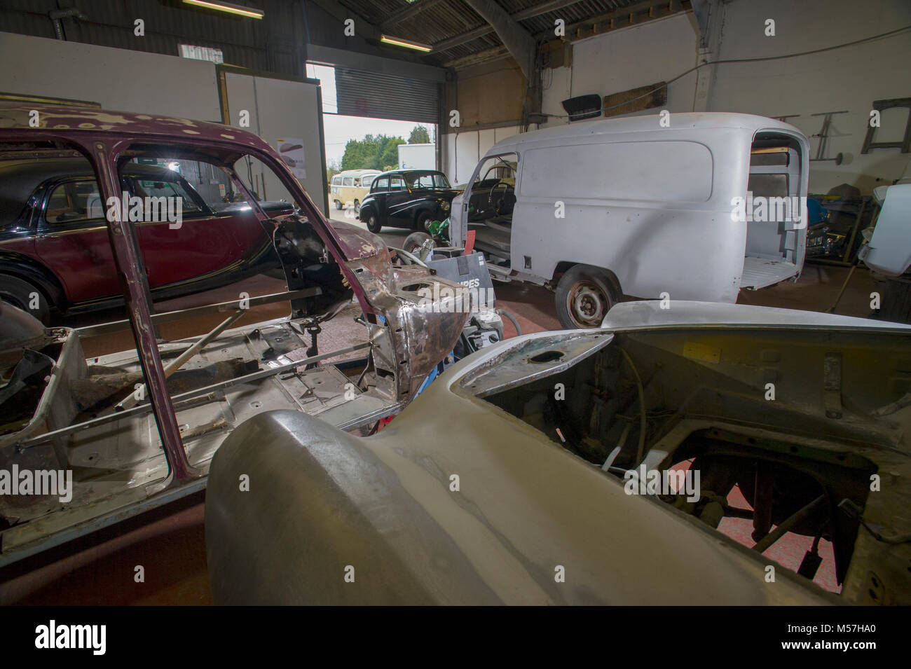 Classic car workshop filled with projects Stock Photo - Alamy