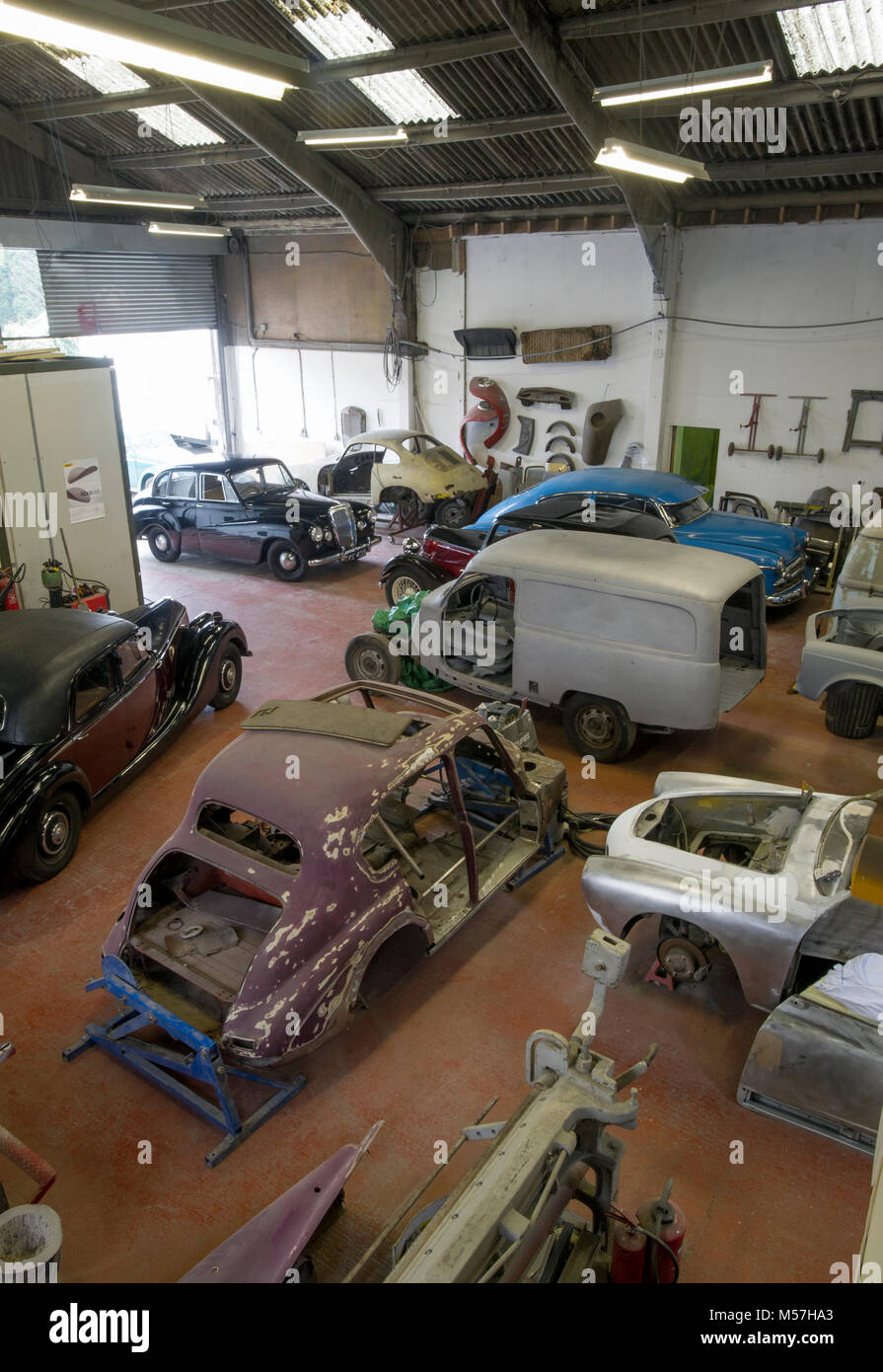 Classic car workshop filled with projects Stock Photo - Alamy