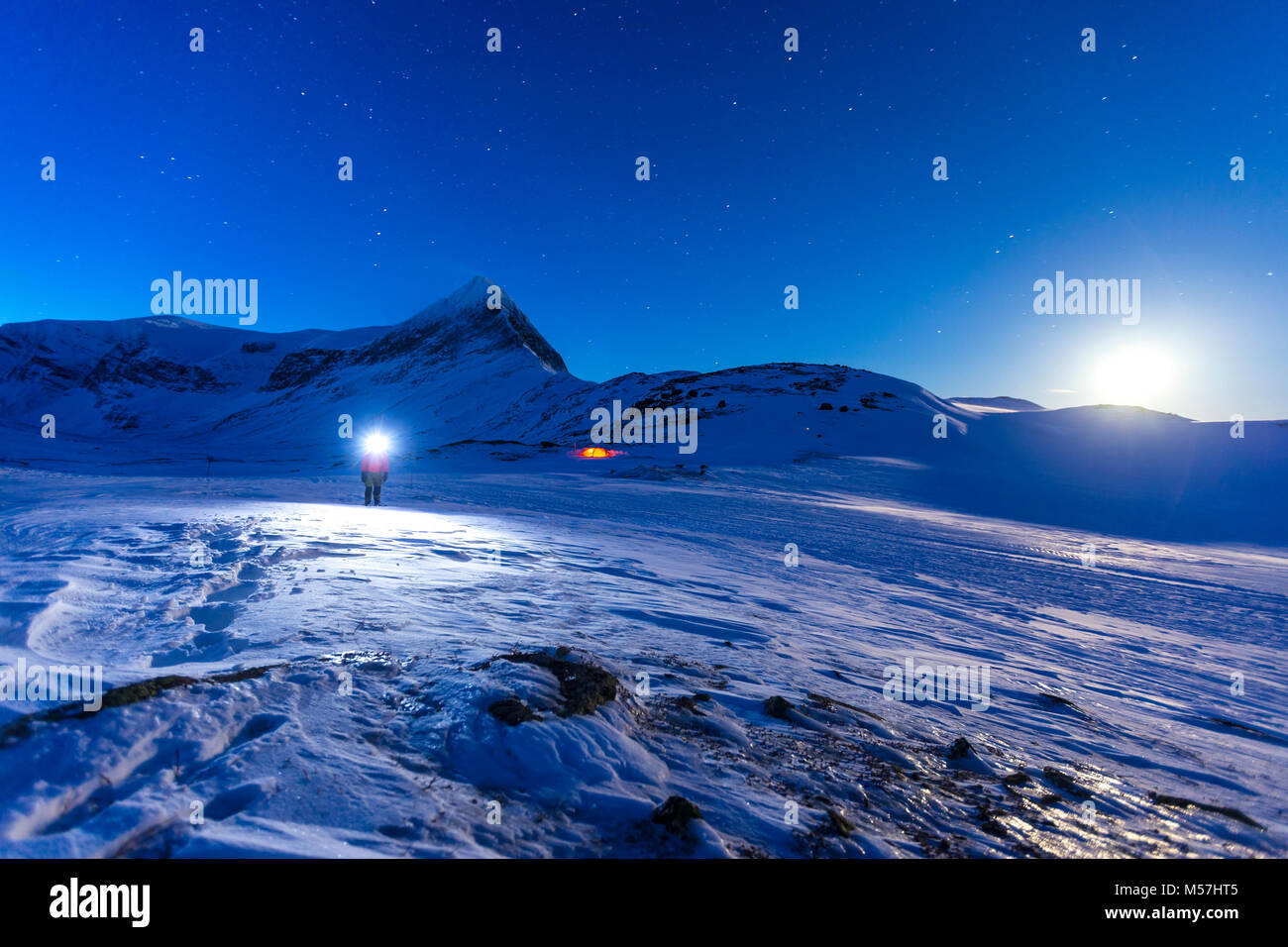 Person with tent on full moon in the snow,Kungsleden or king's trail,Province of Lapland,Sweden,Scandinavia Stock Photo
