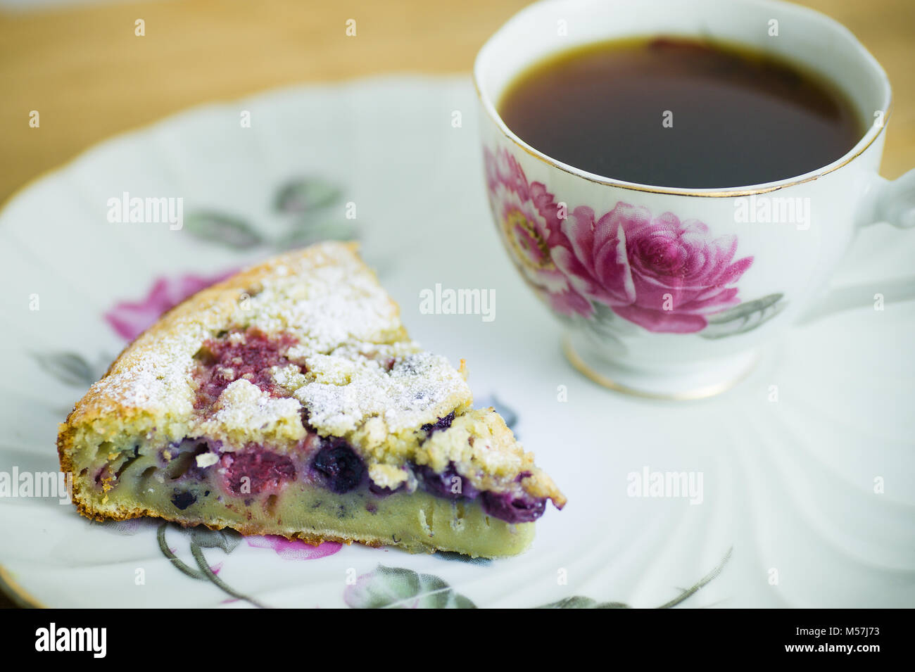 antique floral rose tea cup and plate with berry pastry and black ...