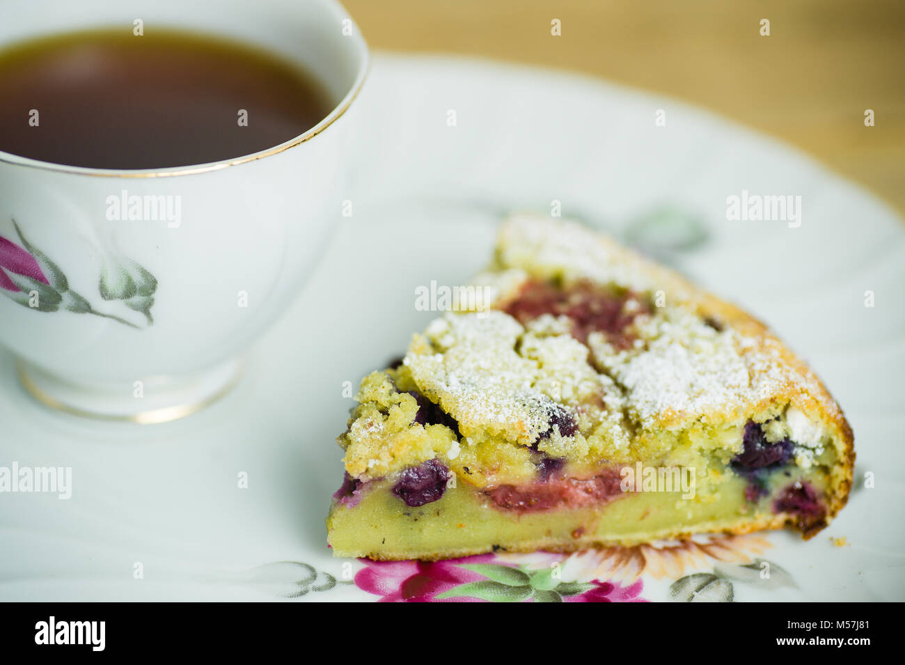 antique floral rose tea cup and plate with berry pastry and black ...