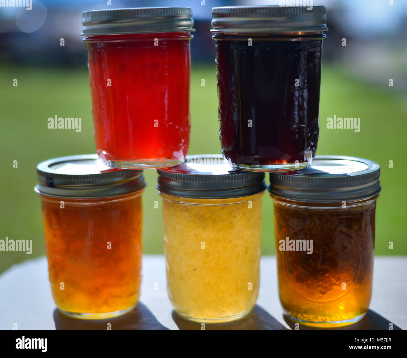 homemade jam, jelly and pickles. canned goods by grandma Stock Photo