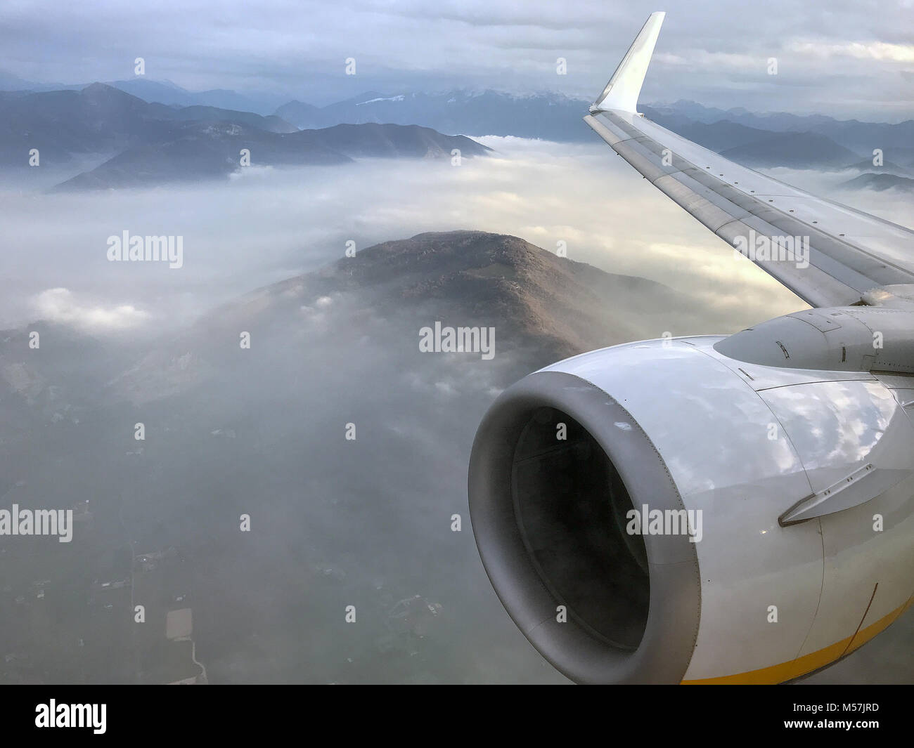 Aerial view on fogy mountains from airplane Stock Photo - Alamy