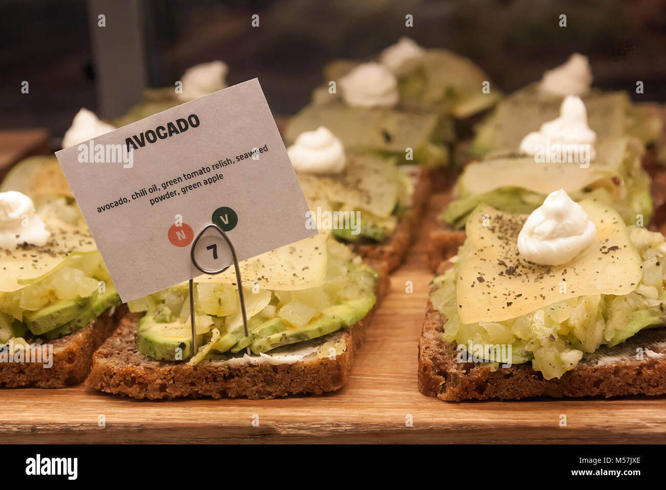 Sign for an avocado open sandwich on display in a food court restaurant. Stock Photo