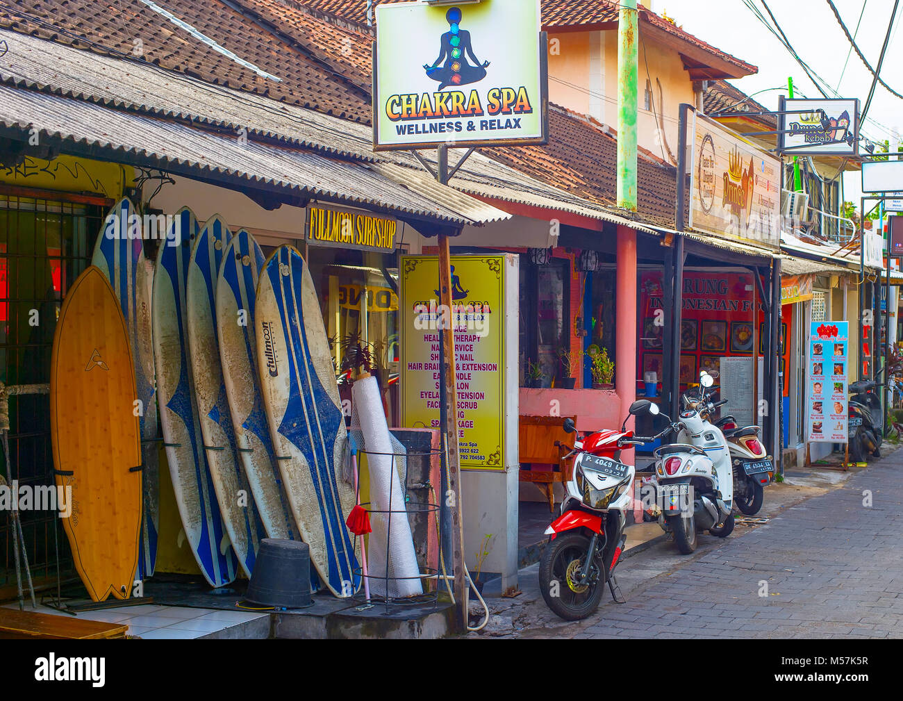 KUTA, BALI ISLAND, INDONESIA - JAN 28, 2017: Street with local touristic shops in Kuta. Kuta is the most famous and crowded tourist destination on Bal Stock Photo