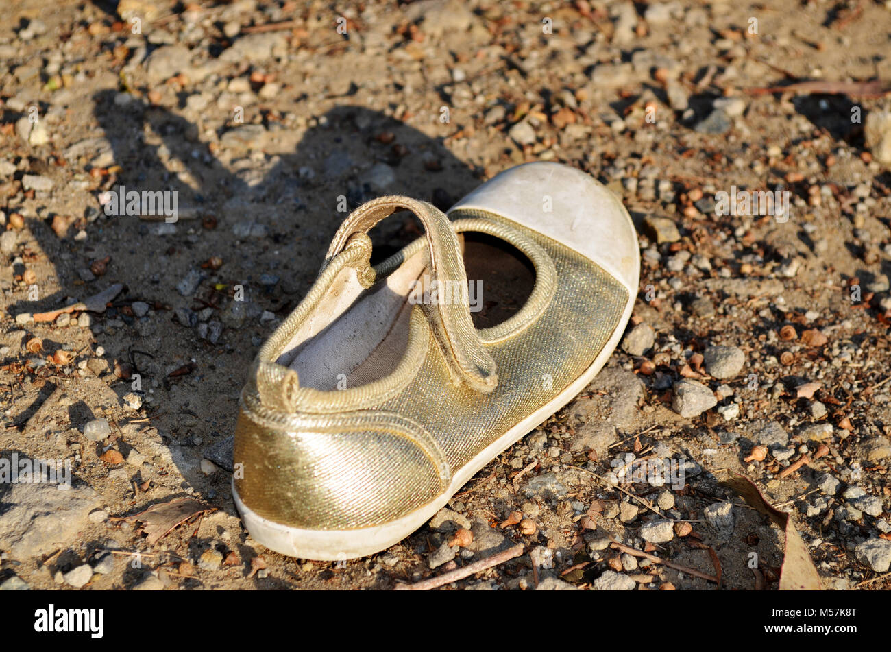 Child's golden lost shoe Stock Photo