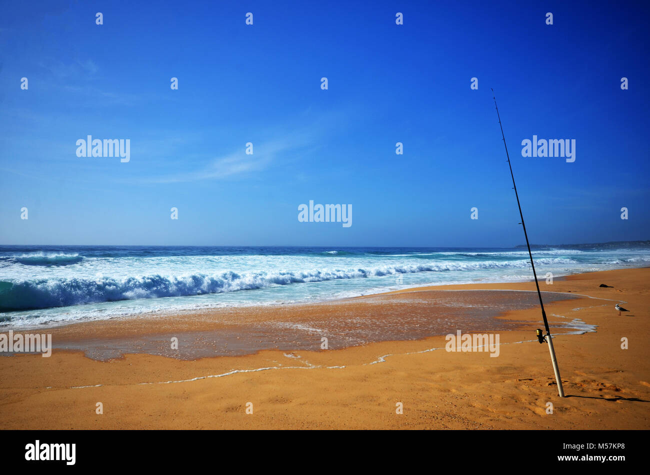 Self isolation Fishing rod on beach Stock Photo