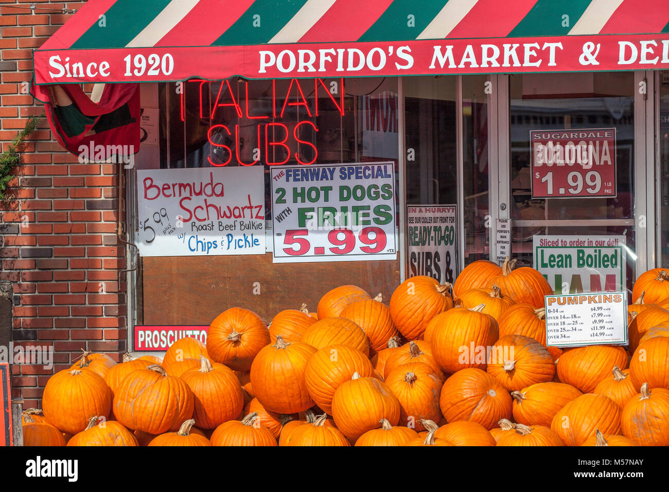 Facade of Porfido's Market & Deli, an old-style Italian market open since 1920 on the Main St. of Littleton, NH, USA, has a huge pile of pumpkins for  Stock Photo