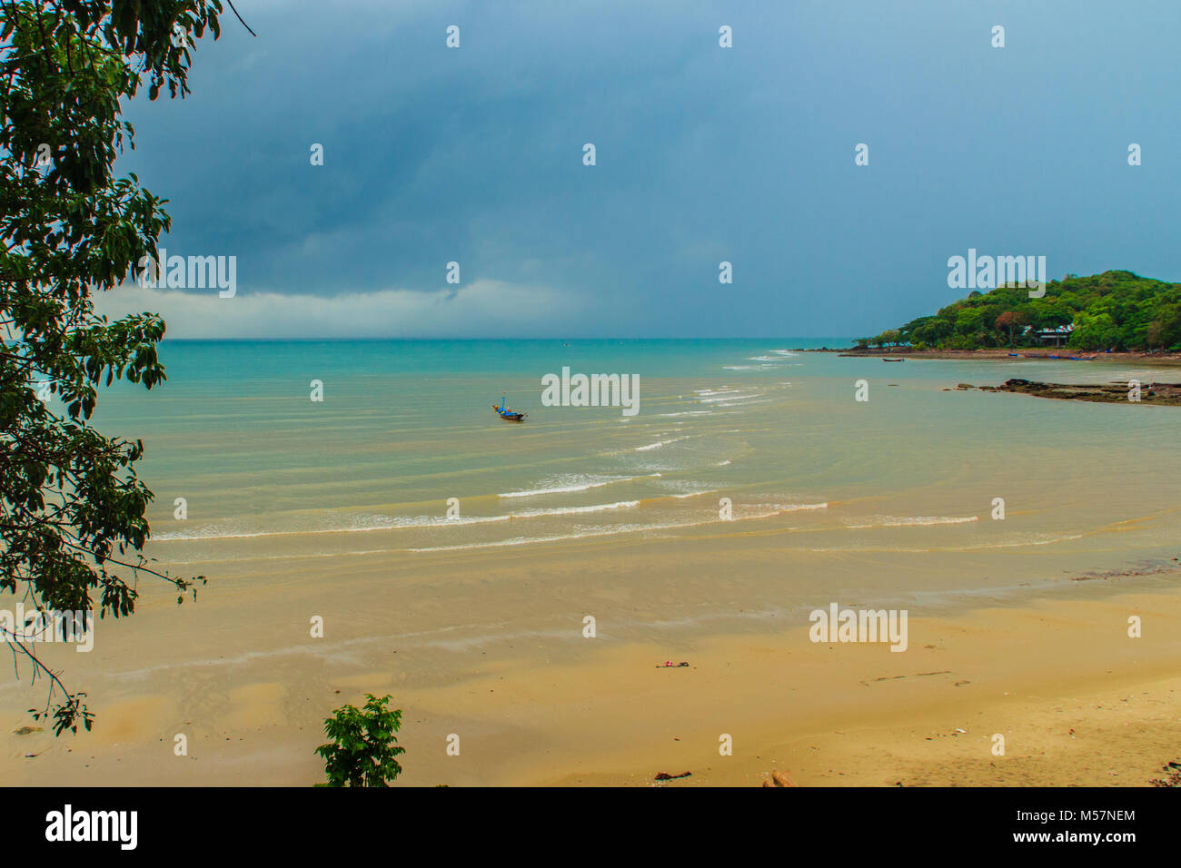 Peaceful seascape view with fisherman village on the beach in the rainy seasons at Hinsuay Namsai beach, Rayong, Thailand. Stock Photo
