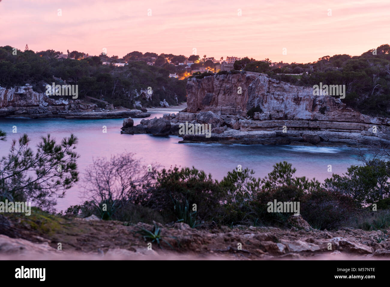 View of a colorful sunset over Cala Llombards in Mallorca, Spain. Stock Photo