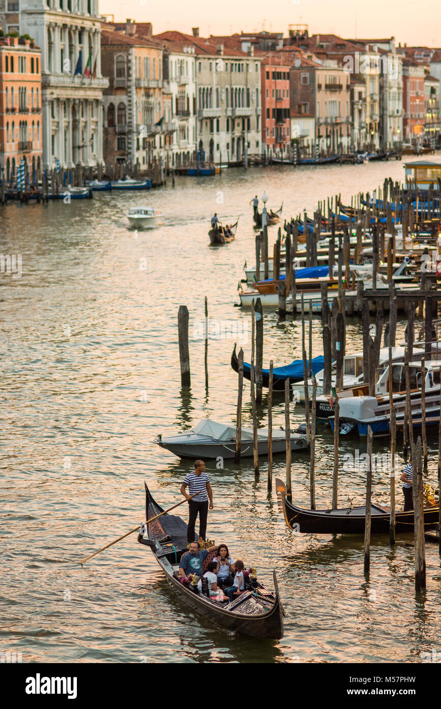 the Grande canal in Venice under the sunset with venetian gondolas paddling away in the distance Stock Photo