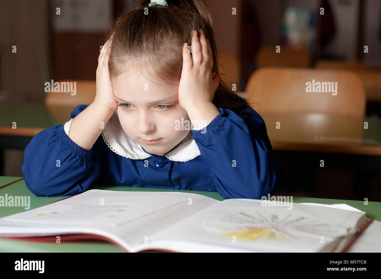 Tired, bored, frustrated and overwhelmed italian first-grader on Stock Photo