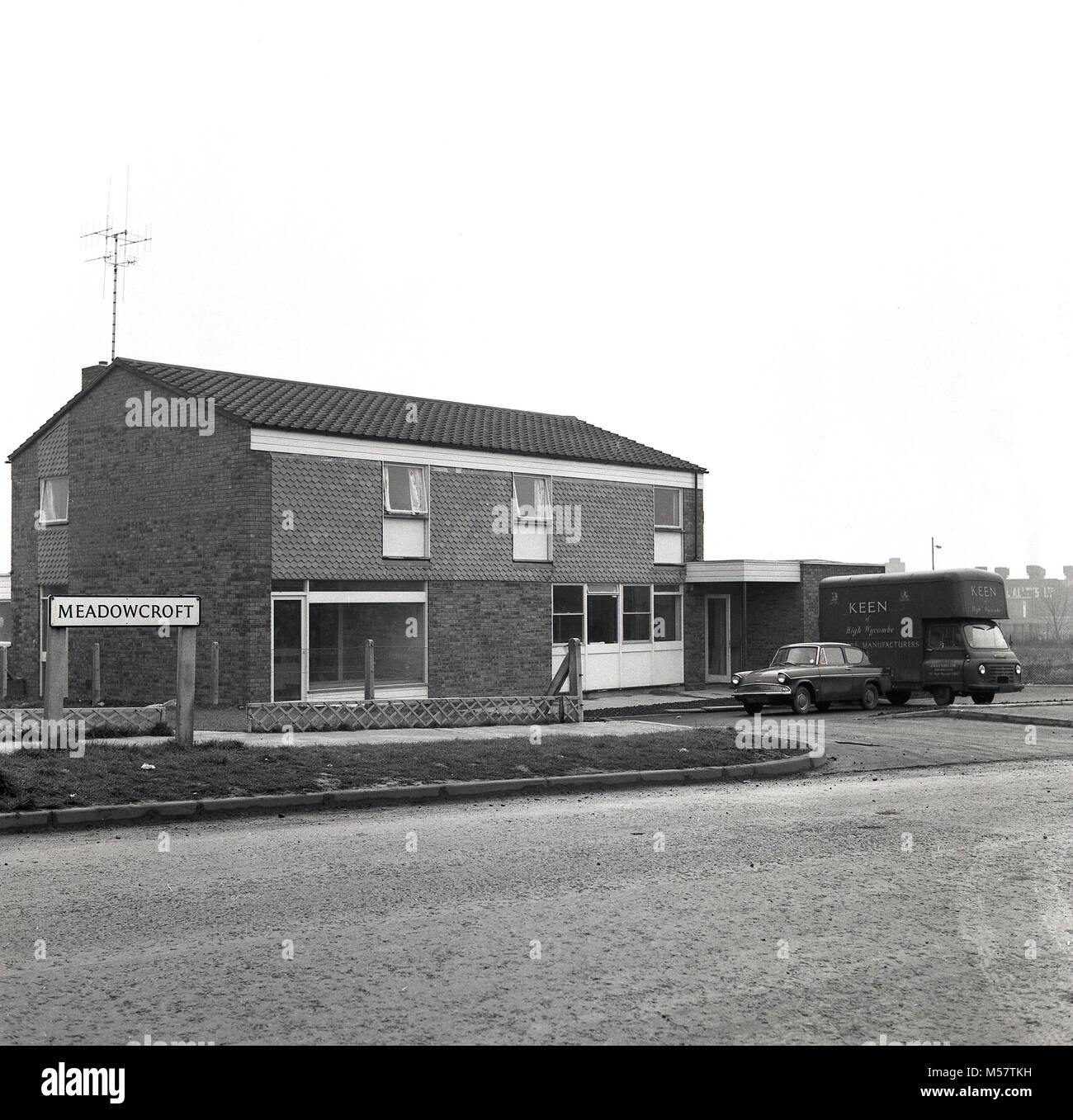 1965, historical picture shows a new building on a housing estate recently built at Meadowcroft, Aylesbury Bucks, England, UK. The building originally designed as a house or two houses would be adapted to become a community pub, The John Kennedy, named after the famous American President, JFK. Stock Photo