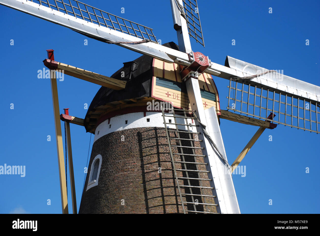close up of a Dutch windmill against a blue sky Stock Photo