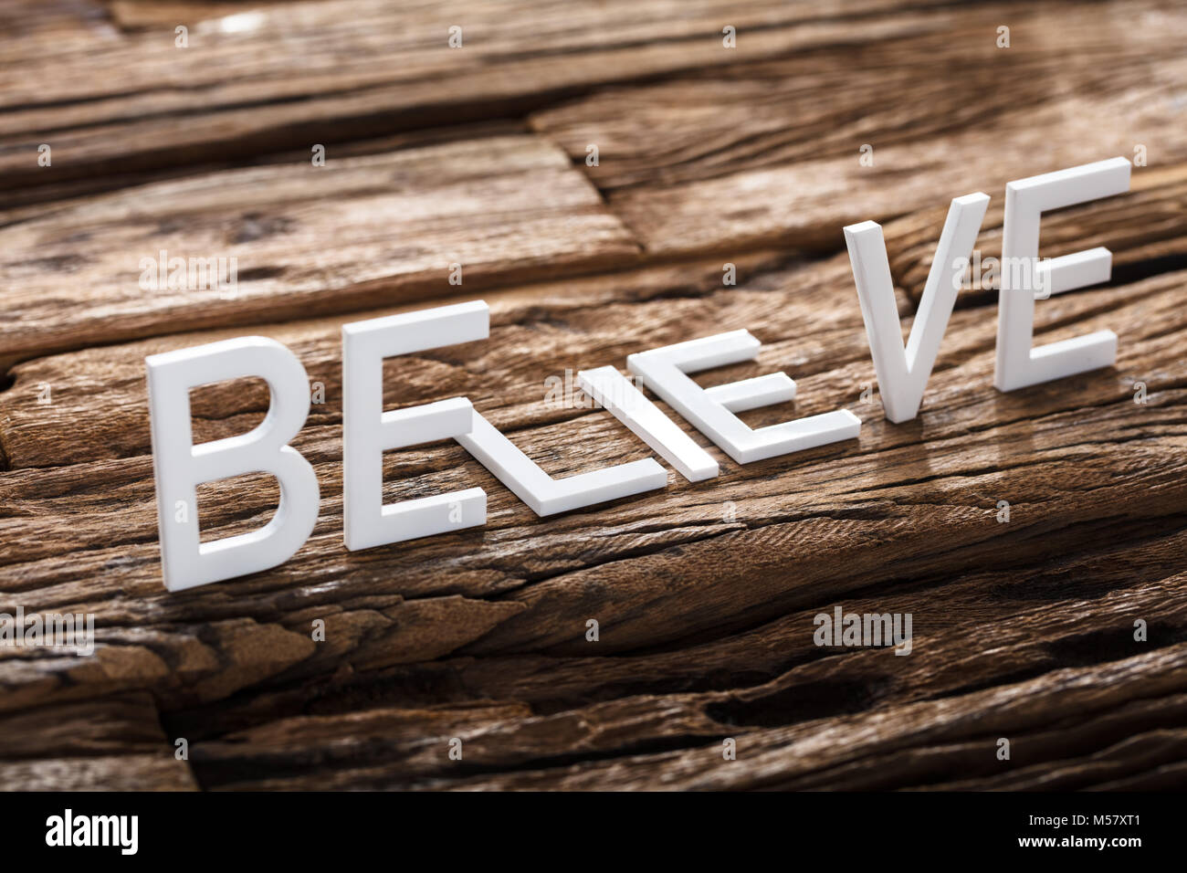 Closeup of believe or lie words on wood Stock Photo