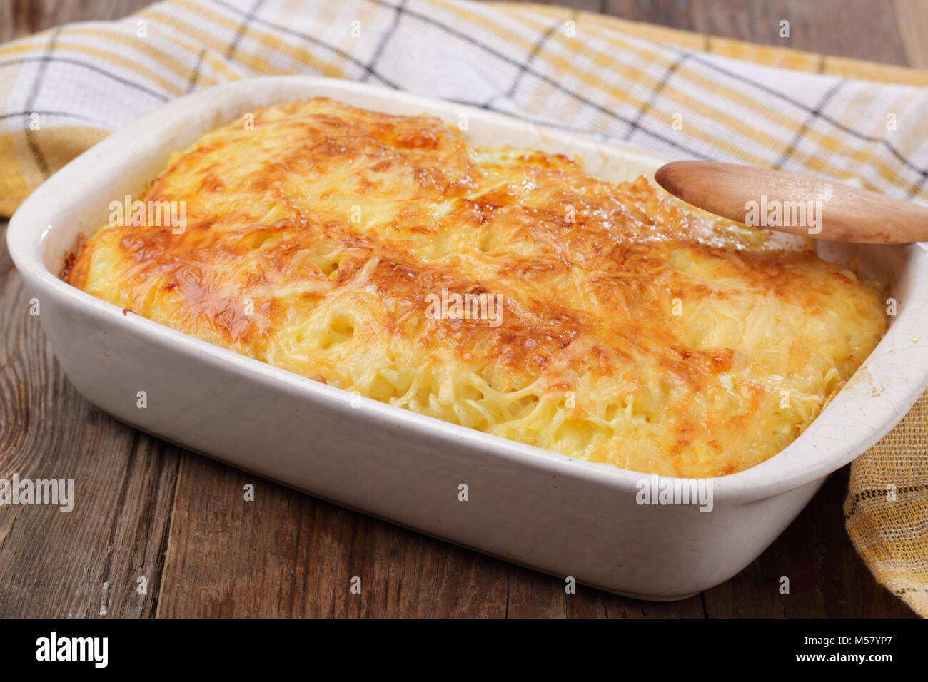 Gratin with pasta, beaten eggs, and cheese, in white casserole Stock Photo