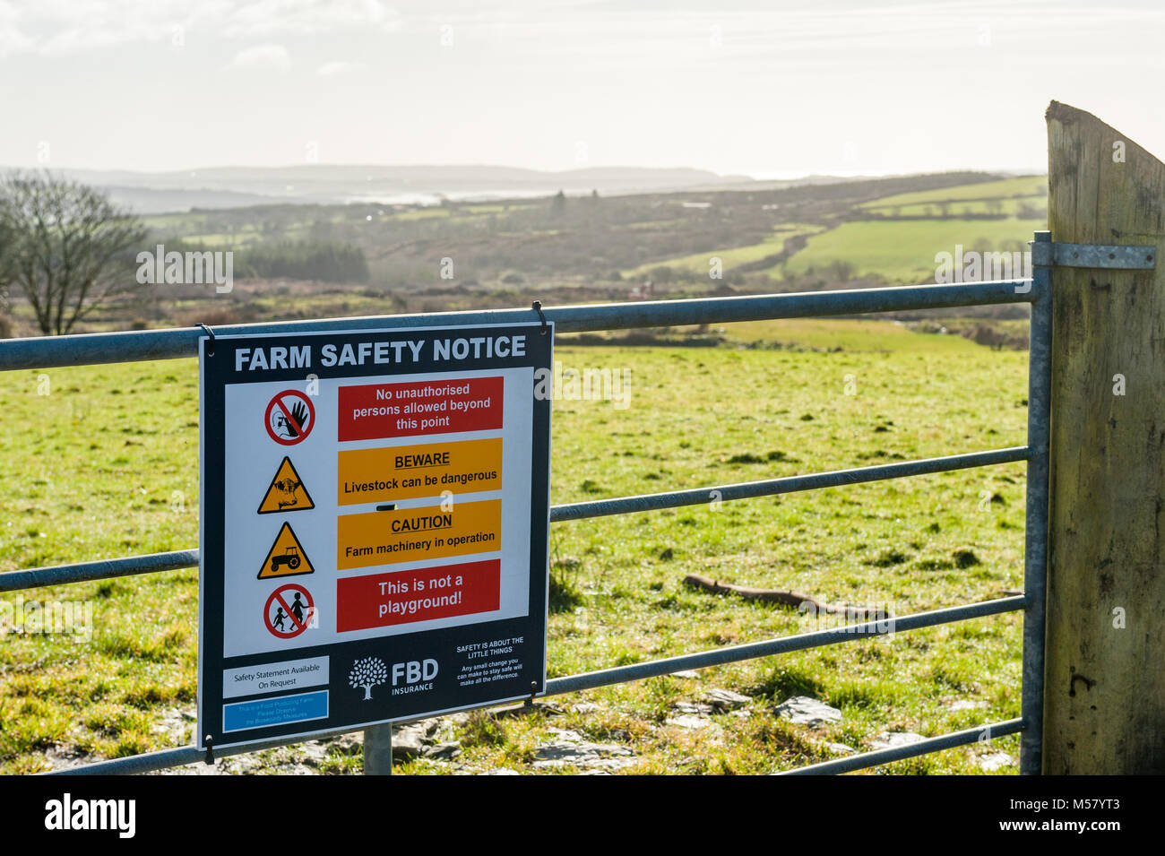 Farm safety notice on a farm gate in Ballydehob, County Cork, Ireland with Roaring Water Bay in the background and copy space. Stock Photo