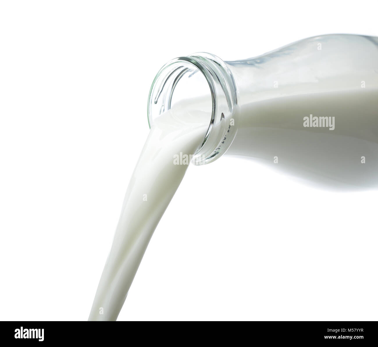 Milk pouring from a bottle isolated on white Stock Photo Alamy