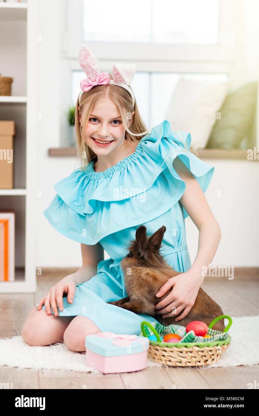 Teenage girl wearing bunny ears holding Easter eggs Stock Photo - Alamy