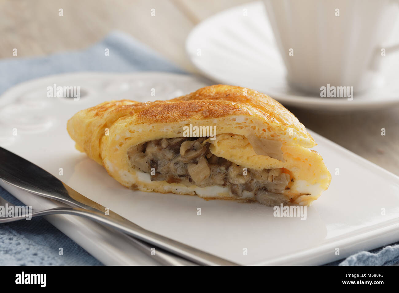 Omelet roll with roasted mushrooms Stock Photo