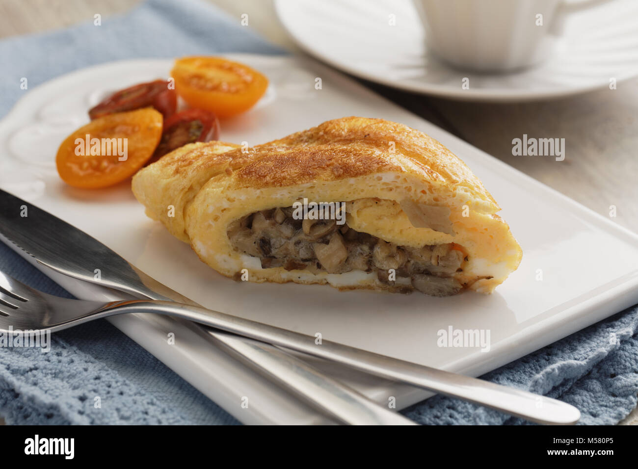 Omelet roll with roasted mushrooms Stock Photo