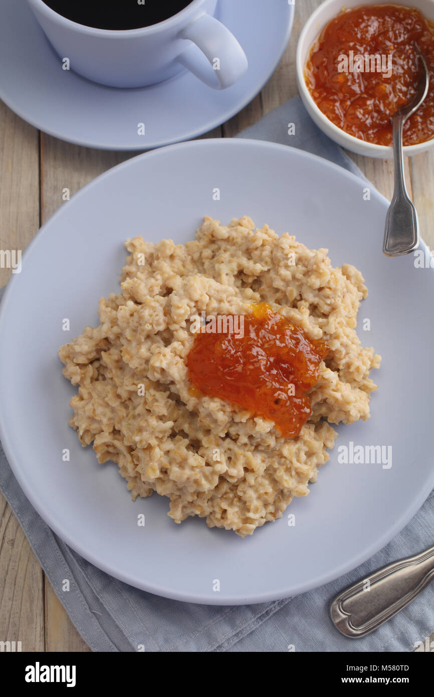 Oatmeal porridge with cloudberry jam Stock Photo