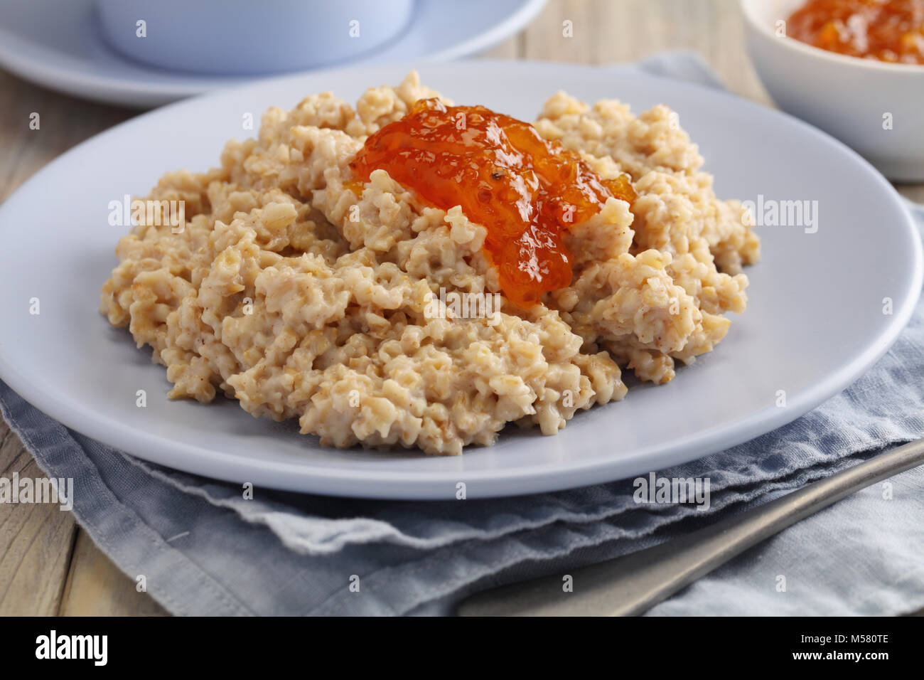 Oatmeal porridge with cloudberry jam Stock Photo