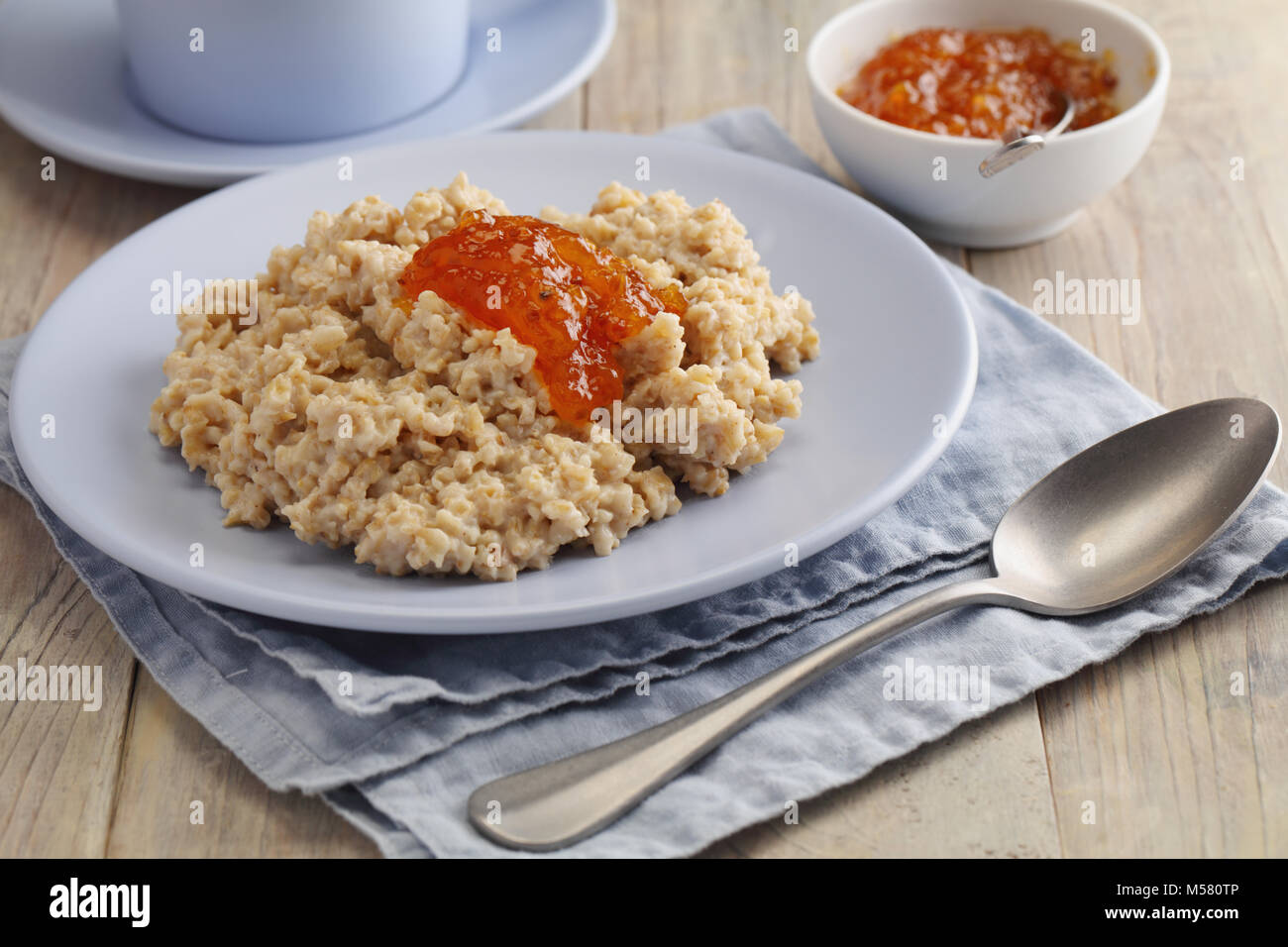 Oatmeal porridge with cloudberry jam Stock Photo