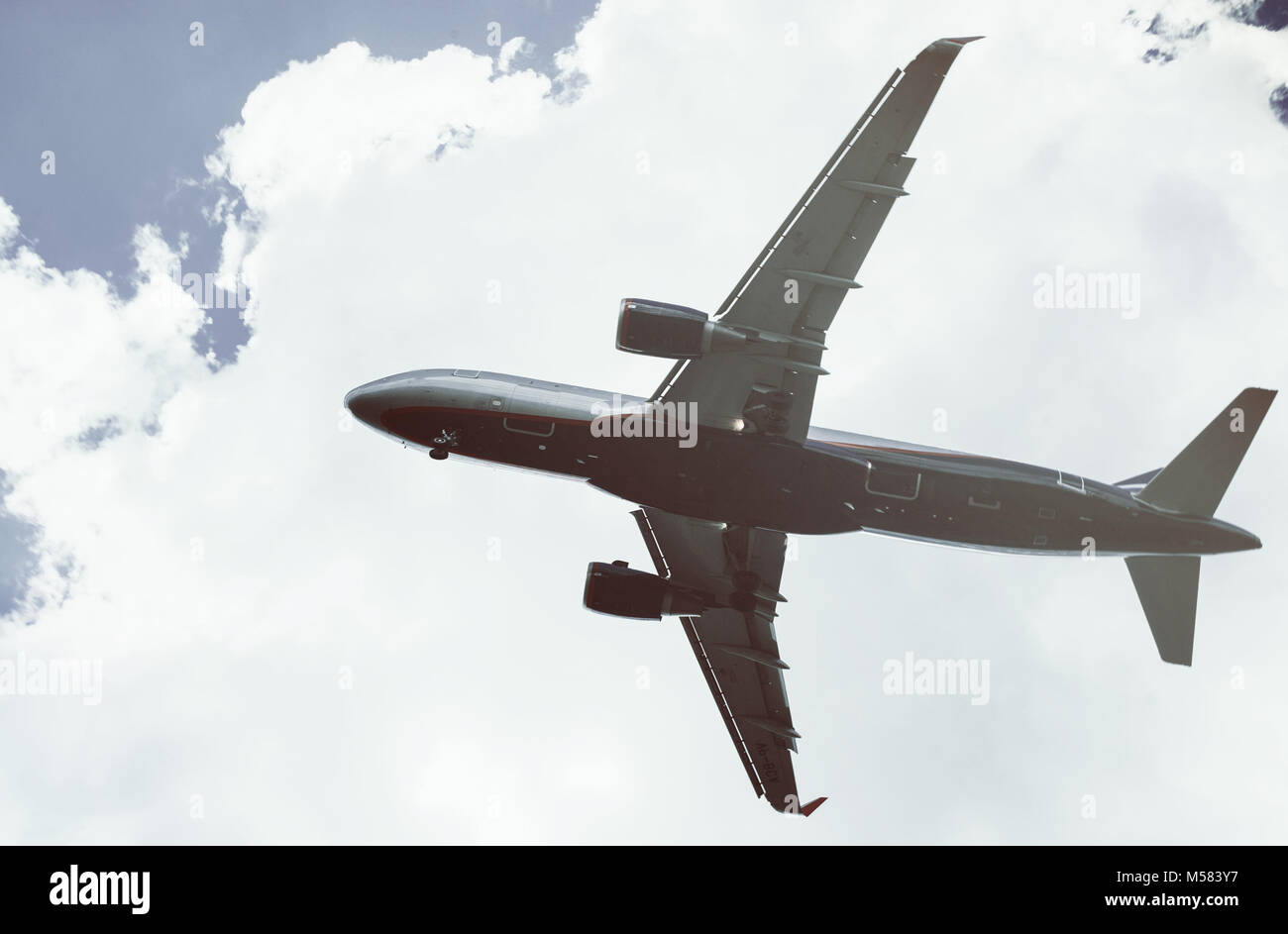 The plane on a background of blue sky and white clouds Stock Photo - Alamy