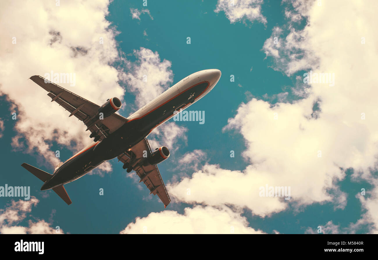 The plane on a background of blue sky and white clouds Stock Photo - Alamy