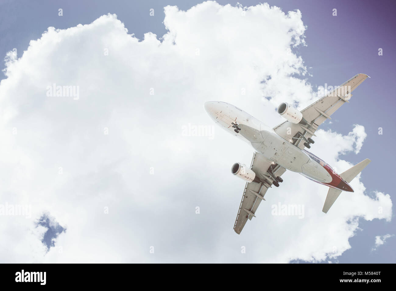 The plane on a background of blue sky and white clouds Stock Photo - Alamy