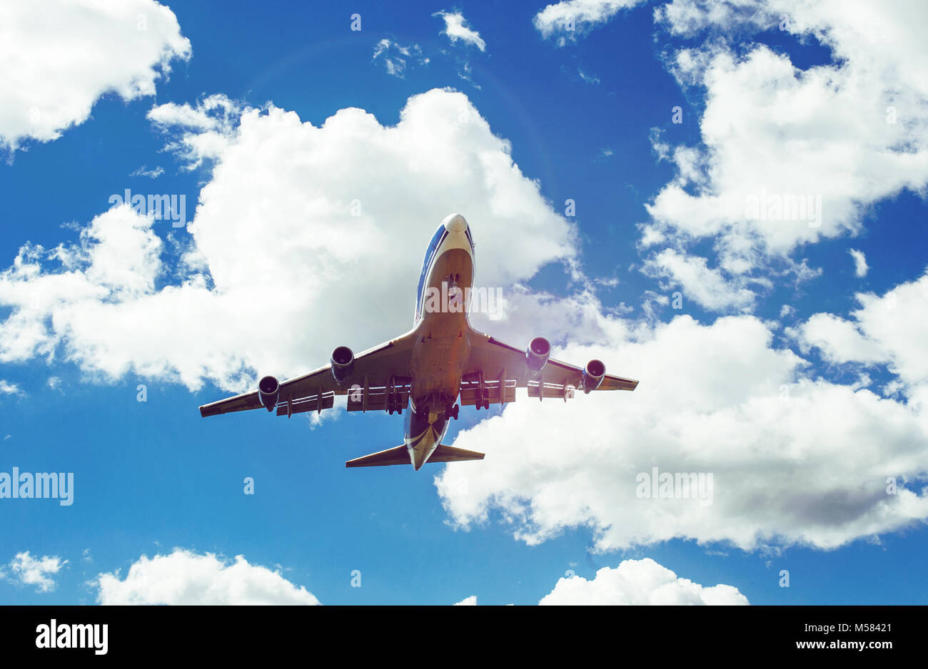 The plane on a background of blue sky and white clouds Stock Photo - Alamy