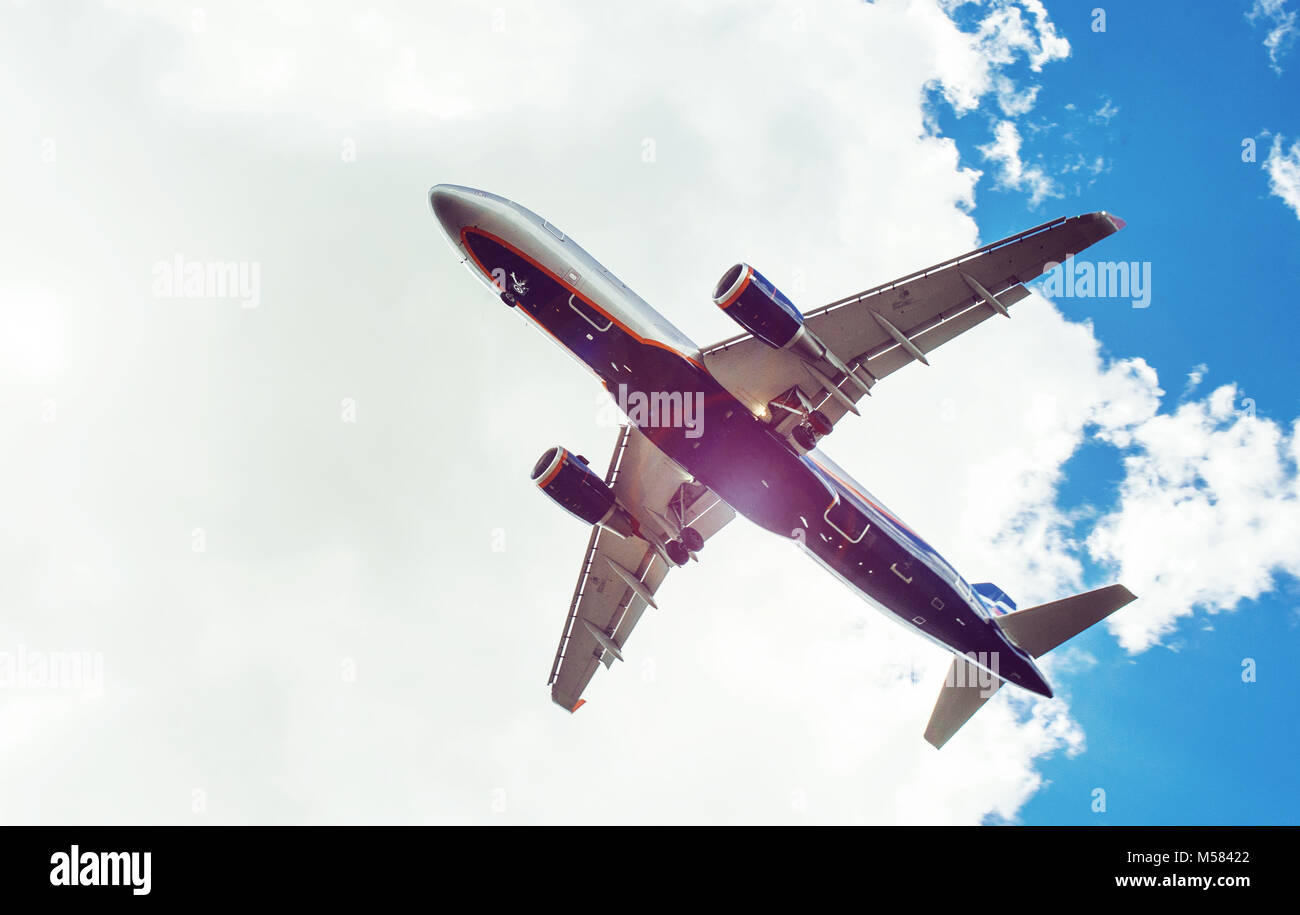 The plane on a background of blue sky and white clouds Stock Photo - Alamy
