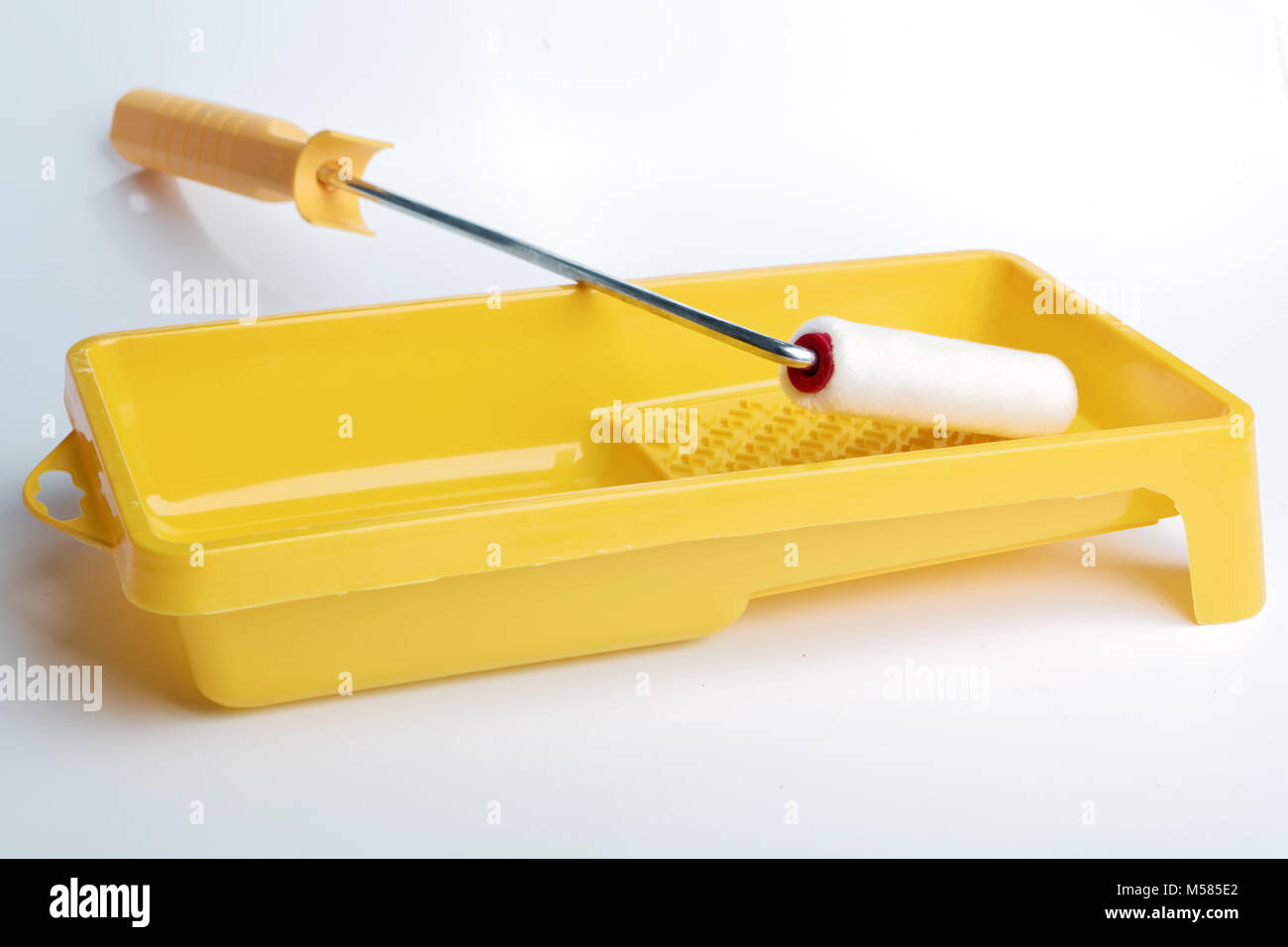 Paint roller, tray, and a can of paint on white background Stock Photo Alamy