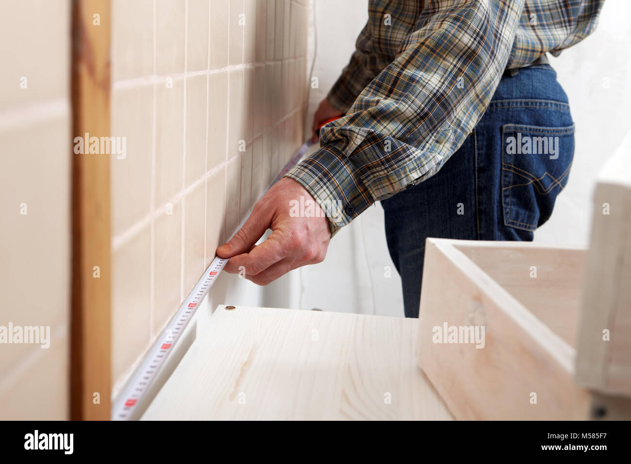 Contractor measuring a kitchen with tape measure Stock Photo Alamy