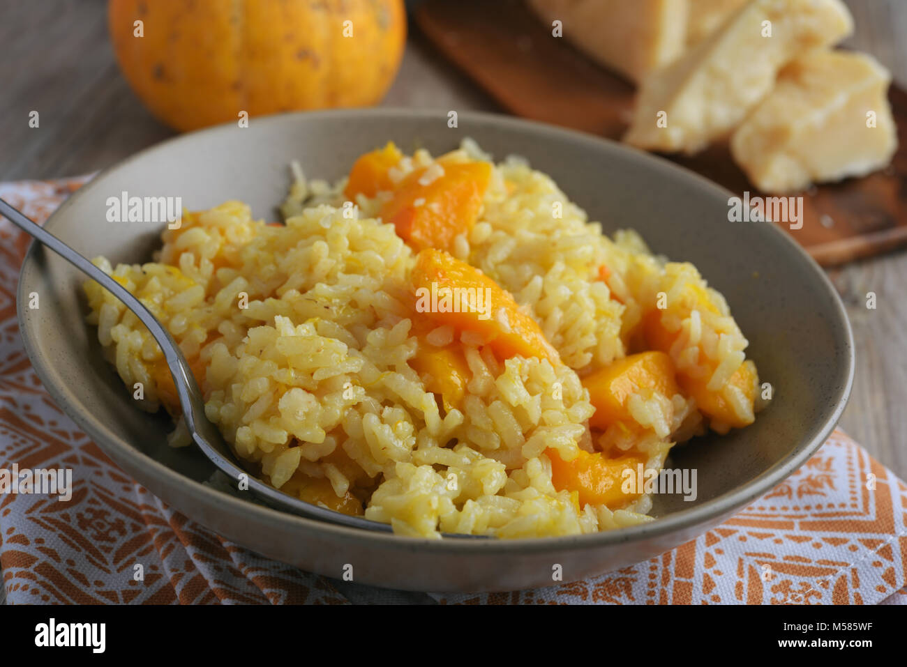 Pumpkin risotto on a rustic table Stock Photo
