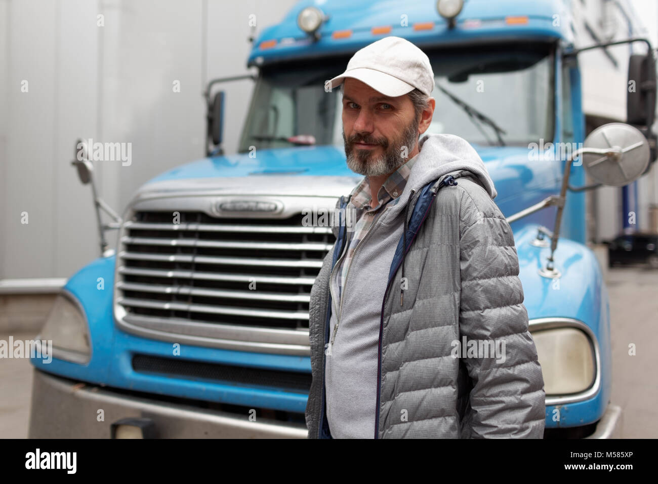 Mature bearded man against retro styled truck Stock Photo