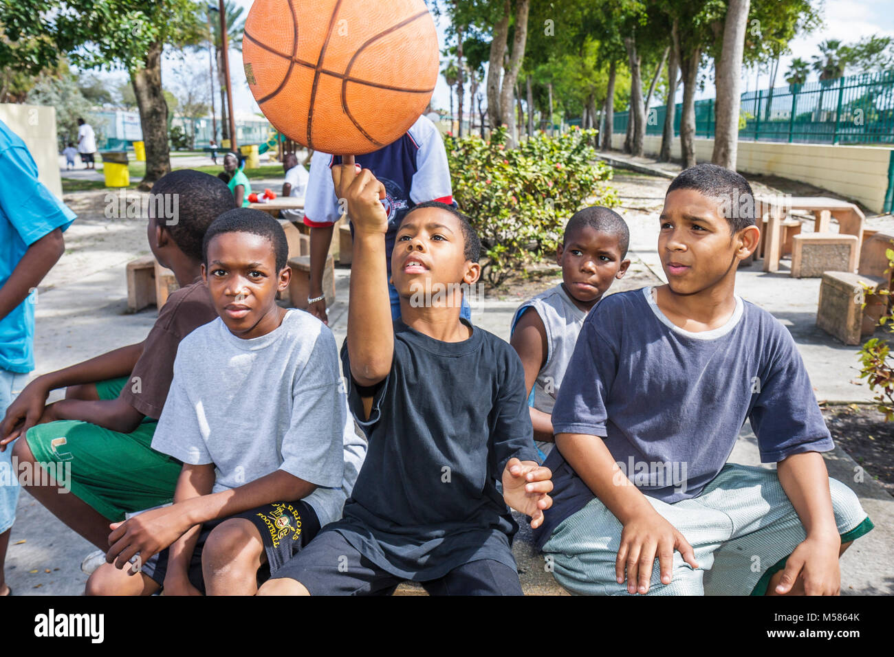 Miami Florida,Liberty City,African Square Park,inner city,low income,poverty,Black boy boys,male kid kids child children youngster,group[,park,playgro Stock Photo