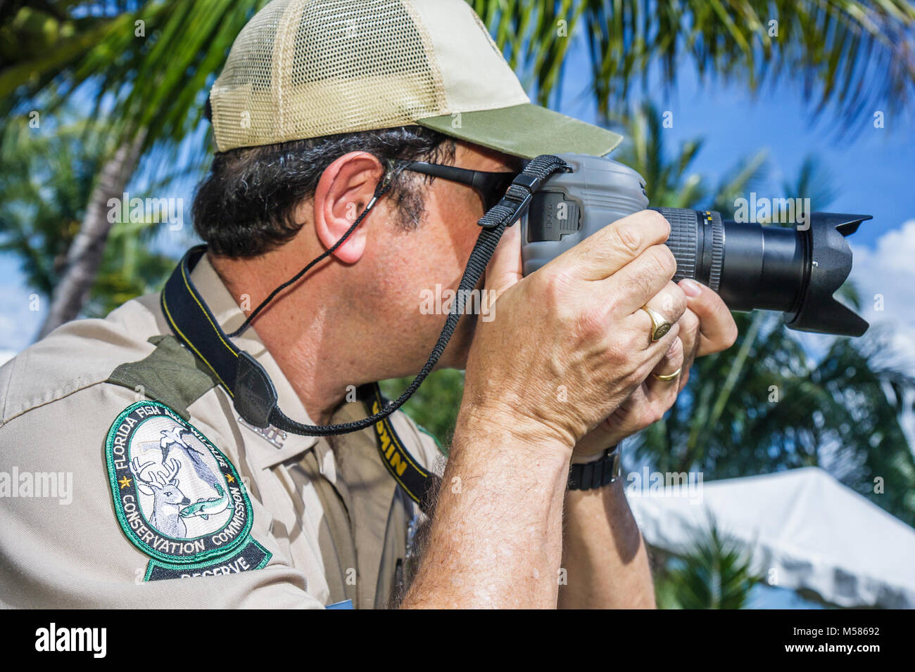 Miami Florida,Metrozoo,Nonnative Pet Amnesty Day,unwanted exotic animals,Fish and Wildlife Conservation Commission,man men male adult adults,camera,di Stock Photo