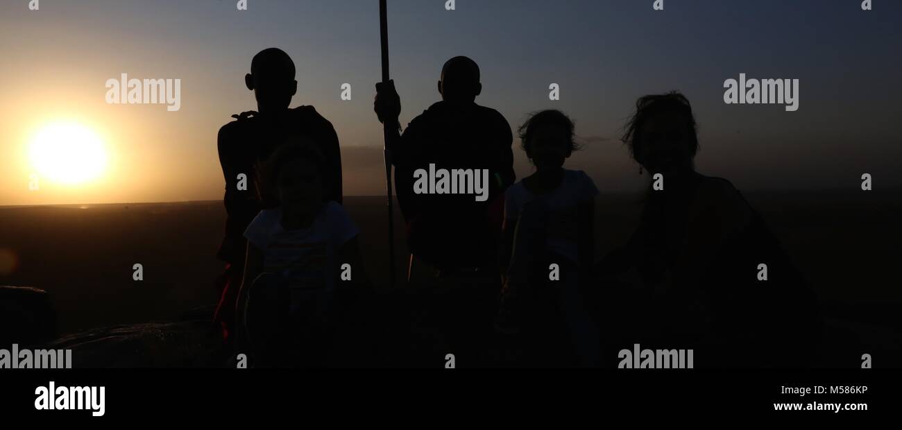 Masai with kids at sunset Stock Photo