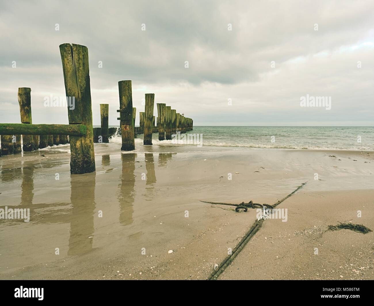 Ship old anchor rope with snap hook and line under sea. Steel shackle ...