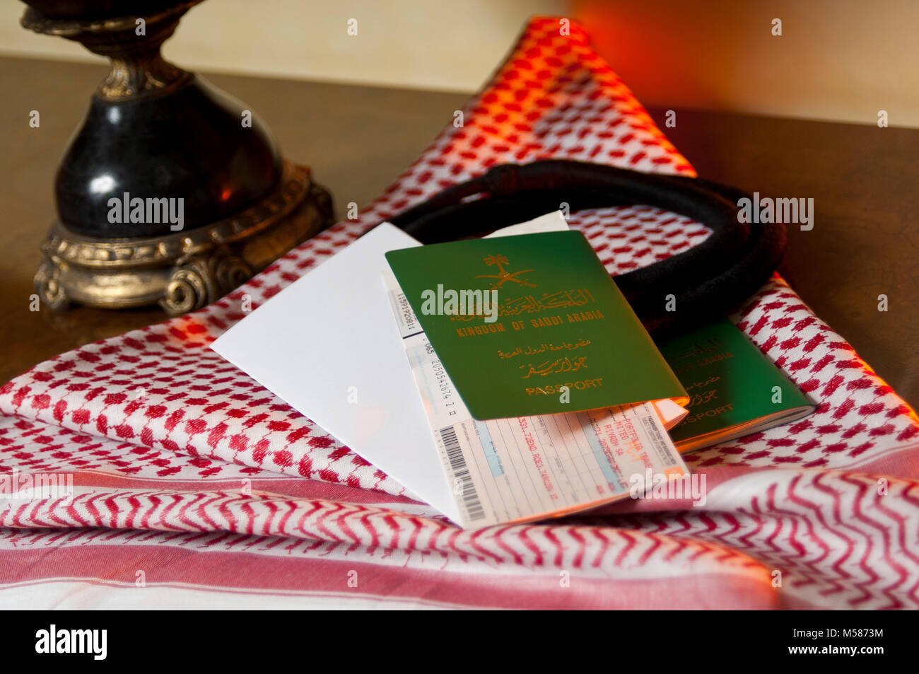 Saudi Traveler Document Passport Flight Ticket Saudi Riyals Money and American Dollars Still Life with Shumagh Head Cover Stock Photo