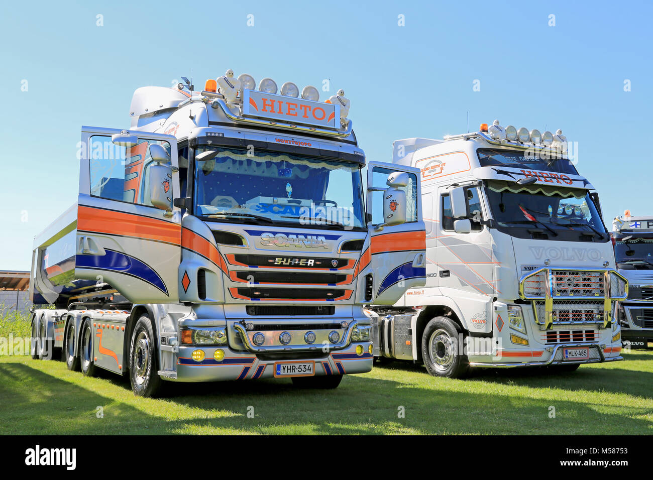 PORVOO, FINLAND - JUNE 28, 2014: Scania V8 and Volvo FH 500 truck tractors on display side by side at Riverside Truck Meeting 2014 in Porvoo, Finland. Stock Photo