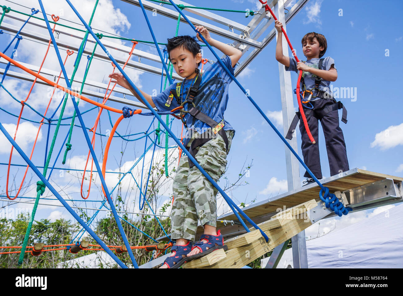 Miami Florida,Homestead,Redlands,Fruit & Spice Park,Asian Culture Festival,festivals fair,boy climbing,safety lines,ropes,sport,outdoor recreation,FL0 Stock Photo