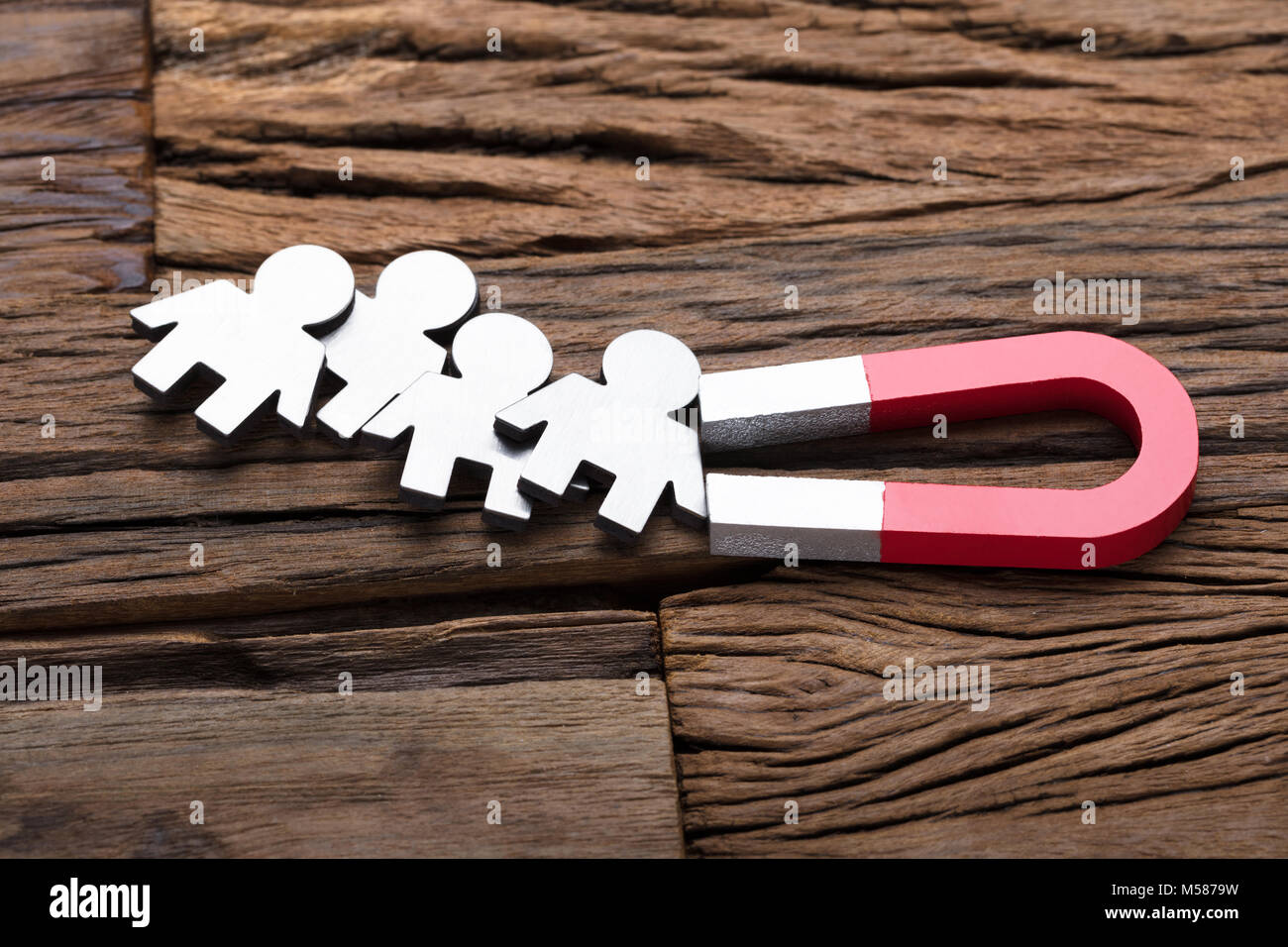 High angle view of magnet attracting traffic on wooden table Stock Photo