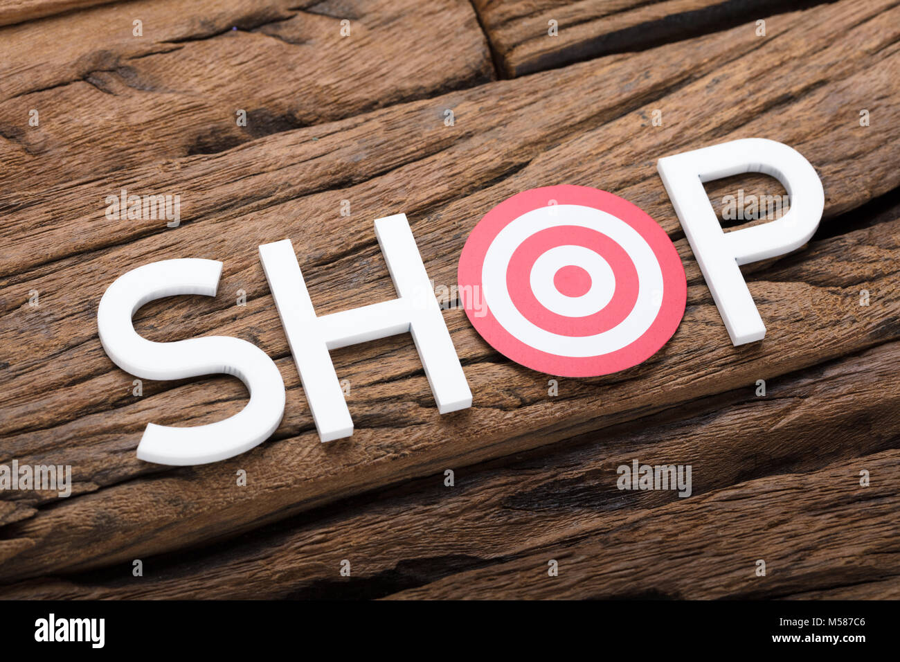 High angle view of shop text with dartboard on wooden table Stock Photo