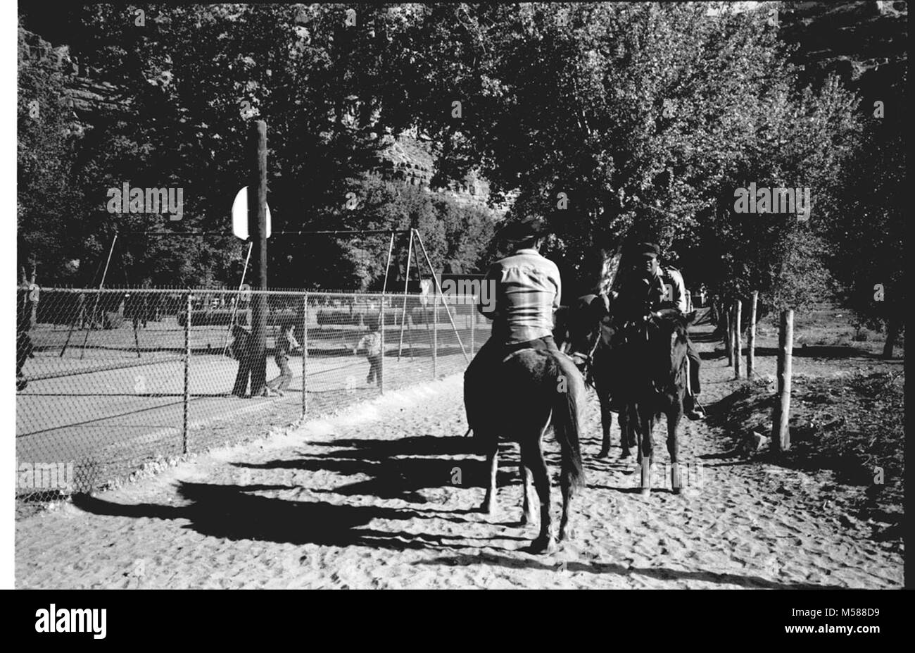 Grand Canyon Historic. SUPAI MEN ON HORSES, RIDING CHILDREN PLAYING IN PLAYGROUND, WHEN THE CAMPGROUND AT HAVASU HAVASUPAI WHEN ADMINISTERED GRCA GRAND CANYON NATIONAL PARK, CIRCA 1977, Stock Photo