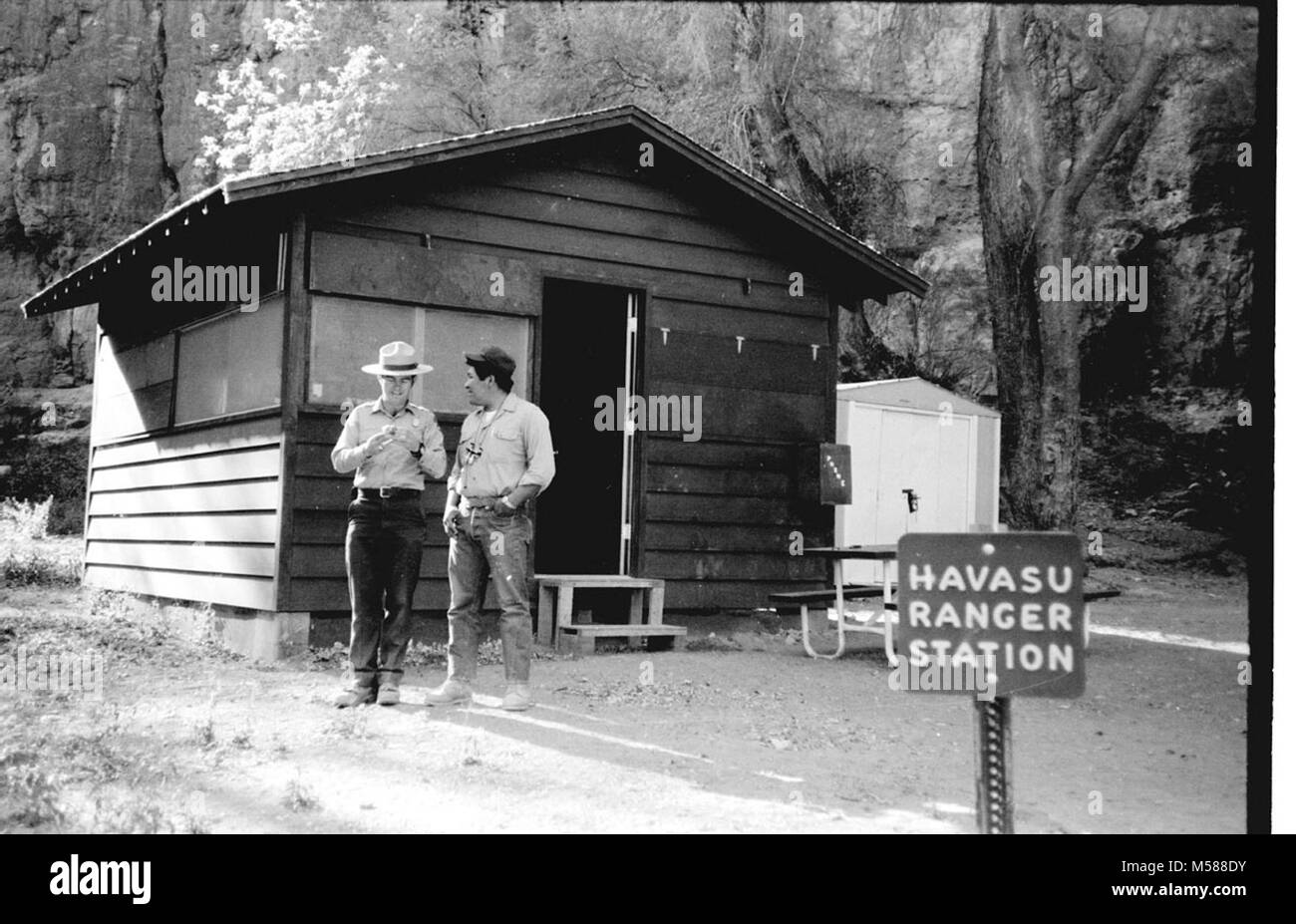 Grand Canyon Historic. ANGLO & SUPAI RANGERS POSE IN FRONT OF RANGER STATION, WHEN THE CAMPGROUND AT HAVASU HAVASUPAI WHEN ADMINISTERED GRCA GRAND CANYON NATIONAL PARK, CIRCA 1977,  . Stock Photo